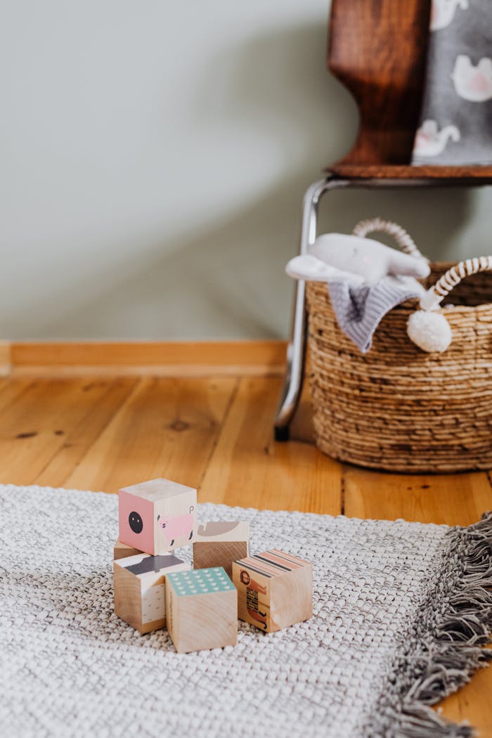A serene nursery corner featuring wooden toys and a woven basket.