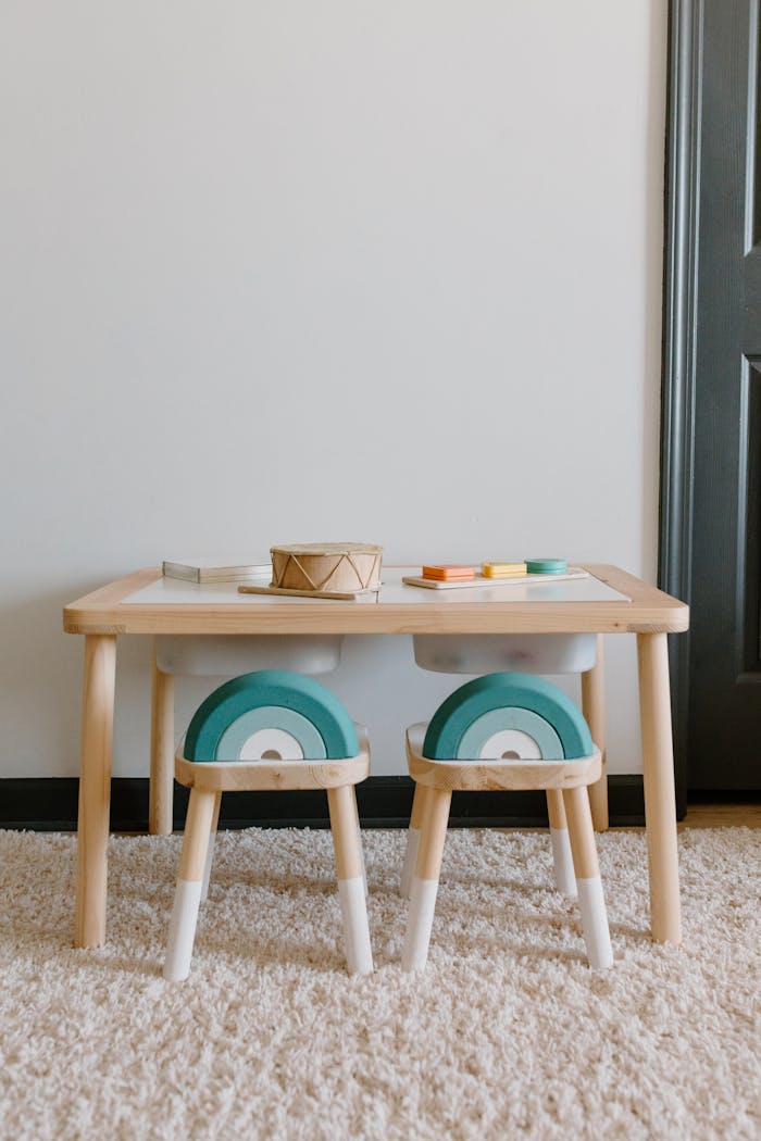 Home Cozy playroom setup featuring a wooden table, chairs, and toys perfect for kids.